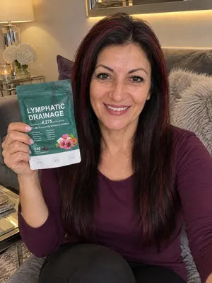 Smiling woman with long dark hair holding a pack of Zeelar softgels